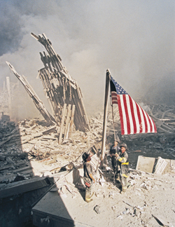 Firefighters raise the American flag at Ground Zero